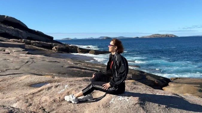 Olga Plotnikova on the granite coast above a turquoise bay near Esperance